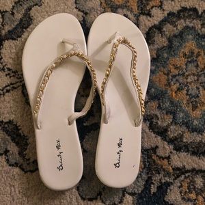 white and gold flip flops